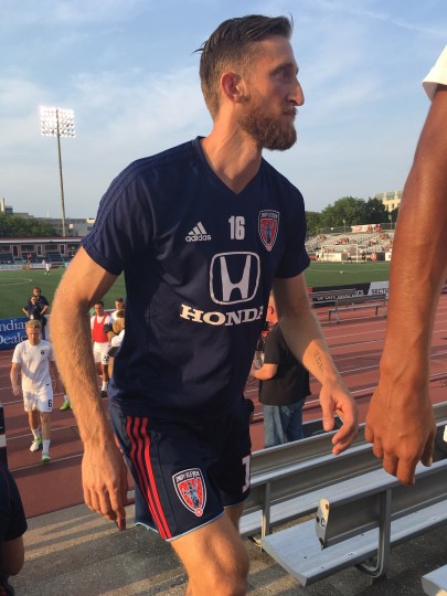 Cory Miller exits the field after pre-game warm-ups